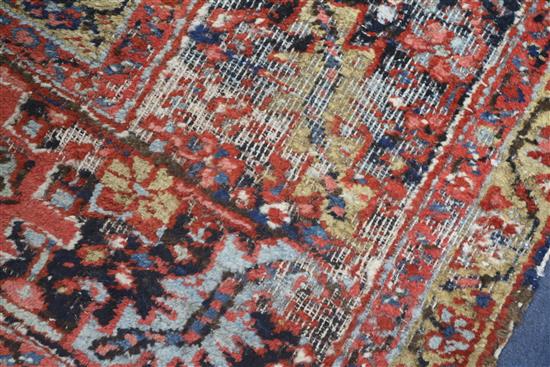 A Persian Heriz red ground carpet, 380 x 280cm, worn